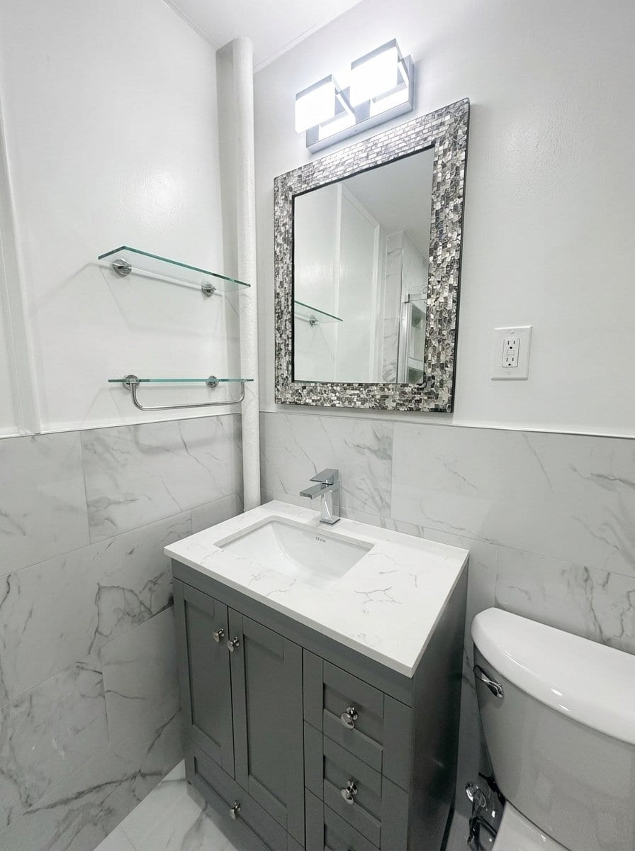 Spa-style bathroom remodel with tiled shower by Excell Homes